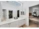 Clean, well-lit bathroom with double sinks, modern cabinetry, and a view to the main bedroom at 5003 88Th E St, Bradenton, FL 34211