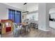 Bright dining area features wood floors, stylish light fixture, and an open view to the modern kitchen at 5003 88Th E St, Bradenton, FL 34211