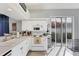 Bright kitchen with white cabinetry, modern appliances, and a sliding glass door to the outside at 5003 88Th E St, Bradenton, FL 34211