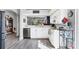 Eat-in kitchen with white cabinets, stainless steel appliances, and open view to dining area at 5003 88Th E St, Bradenton, FL 34211