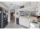 Kitchen area with white cabinets and view to a living area at 5003 88Th E St, Bradenton, FL 34211