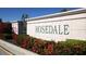 Welcoming Rosedale community entrance sign surrounded by vibrant red flowers and lush landscaping at 5003 88Th E St, Bradenton, FL 34211