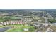 Stunning aerial view of a community with well-manicured lawns, and lush green golf courses at 5105 Pine Shadow Ln, North Port, FL 34287