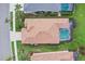 Aerial view of a home featuring a private pool and a well-maintained, colorful yard at 5105 Pine Shadow Ln, North Port, FL 34287