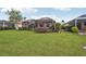Expansive backyard with well-maintained lawn and screened lanai, perfect for outdoor relaxation at 5105 Pine Shadow Ln, North Port, FL 34287