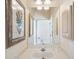 Bright bathroom features a spacious white countertop and a large framed mirror with decorative accents at 5105 Pine Shadow Ln, North Port, FL 34287