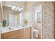 Spacious bathroom with double sinks, a large mirror, and a separate toilet room at 5105 Pine Shadow Ln, North Port, FL 34287