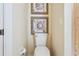 Cozy bathroom featuring a toilet with decorative artwork above it at 5105 Pine Shadow Ln, North Port, FL 34287