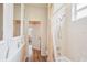Bright bathroom with wood-look flooring and white bathtub shower featuring a beige tiled surround at 5105 Pine Shadow Ln, North Port, FL 34287