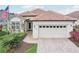 Inviting home with a tile roof, paver walkway, and beautifully landscaped front yard at 5105 Pine Shadow Ln, North Port, FL 34287