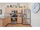 Well-equipped kitchen with stainless steel appliances, granite countertops, and ample wood cabinetry at 5105 Pine Shadow Ln, North Port, FL 34287