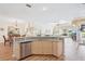 Bright and airy kitchen with an island featuring granite countertops, stainless steel dishwasher and wood floors at 5105 Pine Shadow Ln, North Port, FL 34287