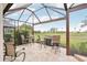 Outdoor patio with seating and golf course view, screened in and perfect for relaxation and entertaining outdoors at 5105 Pine Shadow Ln, North Port, FL 34287