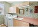 Efficient laundry room equipped with washer, dryer, utility sink, and ample storage space at 5105 Pine Shadow Ln, North Port, FL 34287