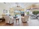 Cozy living room with a view of the pool and lanai through the large window at 5105 Pine Shadow Ln, North Port, FL 34287