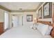Comfortable main bedroom featuring a tray ceiling, tasteful decor, and an ensuite bathroom at 5105 Pine Shadow Ln, North Port, FL 34287