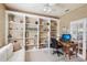 Cozy office space featuring built-in bookshelves, desk, and comfortable seating area, perfect for work at 5105 Pine Shadow Ln, North Port, FL 34287