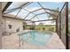 Relaxing screened pool featuring stone decking and golf course views at 5105 Pine Shadow Ln, North Port, FL 34287