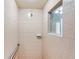 Tiled shower with grab bar and window at 5105 Pine Shadow Ln, North Port, FL 34287