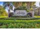 Beautifully landscaped Ashley community entrance sign with lush greenery at 5416 Ashley Pkwy, Sarasota, FL 34241