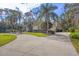 Beautiful home with barrel tile roof surrounded by lush landscaping and a curved driveway at 5416 Ashley Pkwy, Sarasota, FL 34241