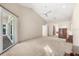 Spacious bedroom featuring a ceiling fan, neutral walls, and a door leading to a screened patio at 5416 Ashley Pkwy, Sarasota, FL 34241