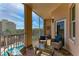 Relaxing balcony featuring comfortable seating and a view of the community pool at 5591 Cannes Cir # 403, Sarasota, FL 34231
