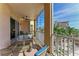 Inviting screened balcony with lounge furniture and view of the pool and landscaping at 5591 Cannes Cir # 403, Sarasota, FL 34231