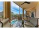 Spacious screened-in balcony with comfortable seating and community views at 5591 Cannes Cir # 403, Sarasota, FL 34231