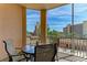 Inviting balcony with seating and views of surrounding buildings and lush greenery at 5591 Cannes Cir # 403, Sarasota, FL 34231