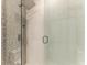 Modern bathroom featuring an elegantly tiled shower with glass enclosure and rainfall showerhead at 5591 Cannes Cir # 403, Sarasota, FL 34231