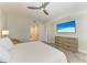 Spacious bedroom with ceiling fan, TV and view into ensuite bathroom at 5591 Cannes Cir # 403, Sarasota, FL 34231