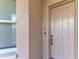 Apartment 403 front door with doorbell on beige stucco exterior at 5591 Cannes Cir # 403, Sarasota, FL 34231