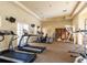 Well-equipped gym featuring treadmills, elliptical machines, and weightlifting equipment and a bookshelf at 5591 Cannes Cir # 403, Sarasota, FL 34231