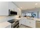 Modern kitchen with quartz countertops and stainless steel appliances at 5591 Cannes Cir # 403, Sarasota, FL 34231