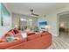Spacious living room with access to a balcony and a mounted TV above console at 5591 Cannes Cir # 403, Sarasota, FL 34231