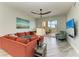 Spacious living room with access to balcony, a mounted television, and modern furniture at 5591 Cannes Cir # 403, Sarasota, FL 34231