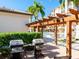 Outdoor grilling station with dual stainless steel grills and a pergola near the community pool at 5591 Cannes Cir # 403, Sarasota, FL 34231