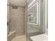Modern shower with pebble floor and patterned tile surround at 5591 Cannes Cir # 403, Sarasota, FL 34231