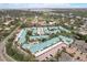 Scenic aerial view of a condo complex with a swimming pool and lush landscaping near the water at 5665 Midnight Pass Rd # 410, Sarasota, FL 34242