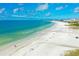 Aerial view of beach with white sand and blue water and some beach goers at 5665 Midnight Pass Rd # 410, Sarasota, FL 34242