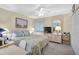 Inviting bedroom with soft lighting, a comfortable bed, ample storage, and a dedicated workspace at 5665 Midnight Pass Rd # 410, Sarasota, FL 34242