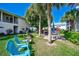 Community outdoor area with multiple seating options surrounded by green space and mature trees at 5665 Midnight Pass Rd # 410, Sarasota, FL 34242