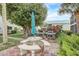 Community outdoor area with dining table, BBQ grills, and lush landscaping, perfect for gatherings at 5665 Midnight Pass Rd # 410, Sarasota, FL 34242
