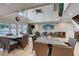 Well-lit community room featuring multiple tables and chairs, perfect for gatherings and events at 5665 Midnight Pass Rd # 410, Sarasota, FL 34242