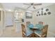 A bright dining space with seating for four, decorative wall plates and a view into the kitchen at 5665 Midnight Pass Rd # 410, Sarasota, FL 34242