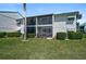 Lush backyard with a screened in porch and an outdoor dining area at 5665 Midnight Pass Rd # 410, Sarasota, FL 34242