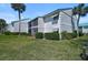 Well-maintained condo building with mature landscaping and screened in lanai at 5665 Midnight Pass Rd # 410, Sarasota, FL 34242