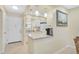 Bright kitchen with a breakfast bar, white cabinetry, and modern appliances, perfect for casual dining at 5665 Midnight Pass Rd # 410, Sarasota, FL 34242