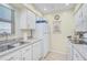 Cozy kitchen with white cabinets and a window over the sink, providing natural light and a cheerful ambiance at 5665 Midnight Pass Rd # 410, Sarasota, FL 34242